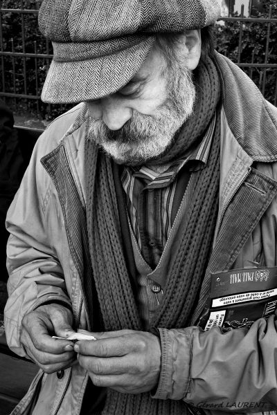 Claude Vasseur se roule une cigarette place des abbesses 75018